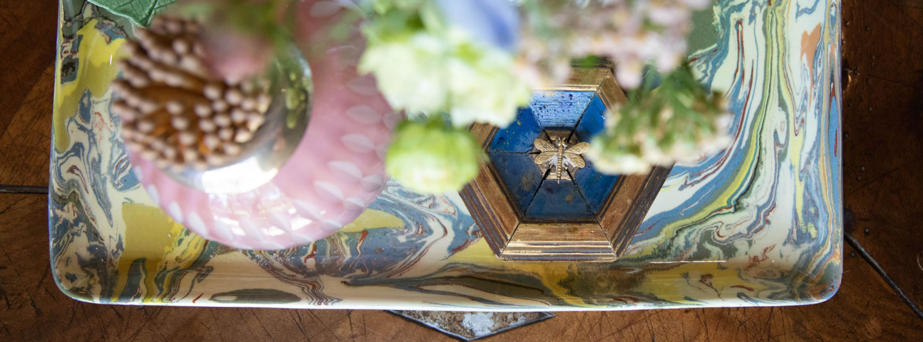 Decorative box with floral and geometric design on a wooden surface